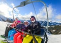 Family riding ski lift cable car on winter vacation skiing Royalty Free Stock Photo